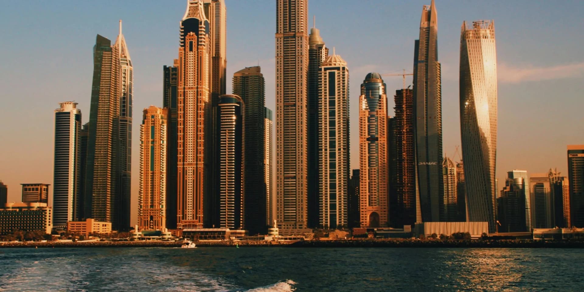 Split view showing commercial office building and residential apartment tower representing investment options in Dubai