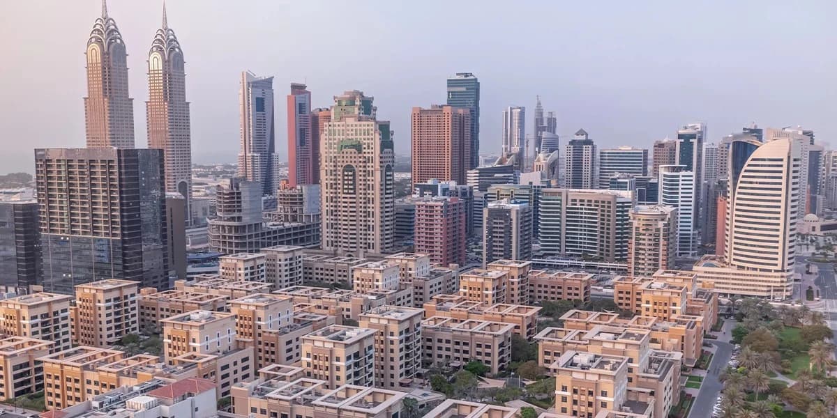 Renter reviewing a Dubai tenancy contract and district cooling bill to compare chiller-free apartment costs