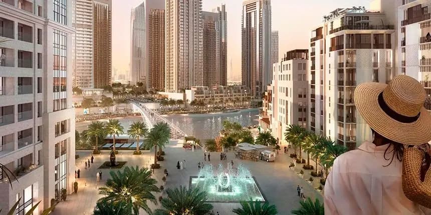 Dubai Marina at night showcasing illuminated luxury towers, waterfront promenade, and vibrant canal-side dining and entertainment